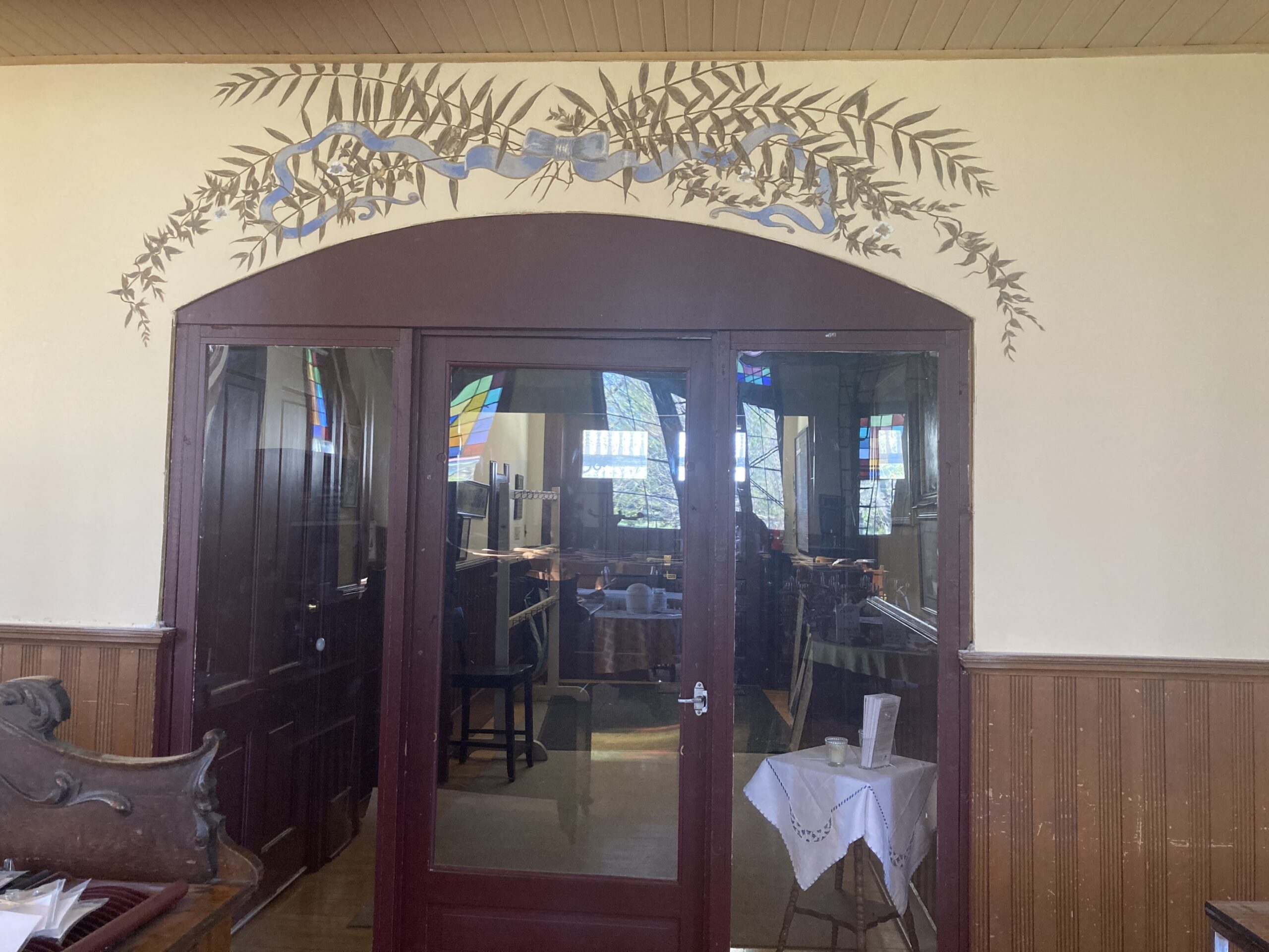 A door featuring an ornate archway above, showcasing intricate designs and craftsmanship.